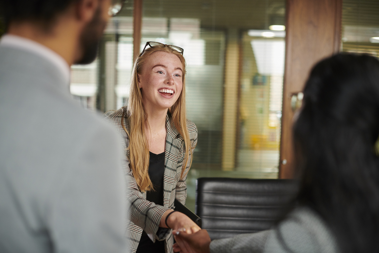 Candidate shaking hands with a panel member at an interview.